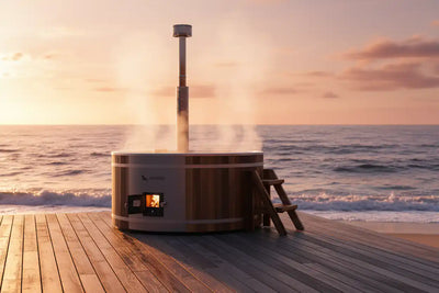 Wooden hot tub on a wooden deck by the ocean at sunset